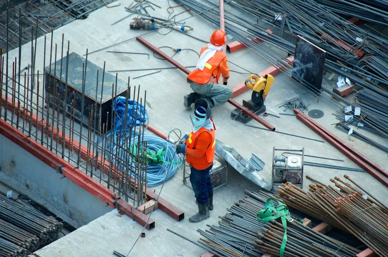 Two builders working on site